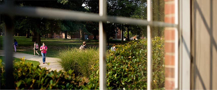 Two male and one female student lounging in chairs.