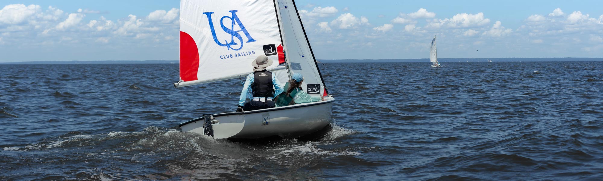 sailing club in a USA branded sailboat on Mobile Bay