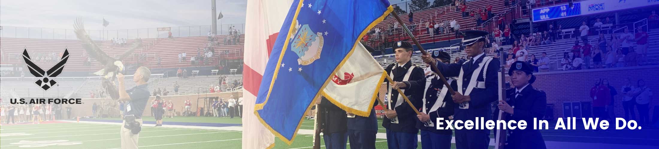 Excellence in all we do overlaying Air Force cadets at football game.