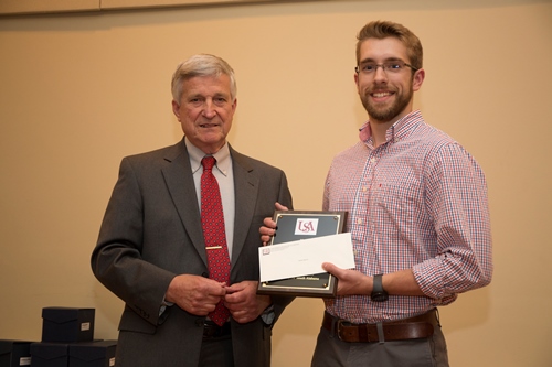 Dr. Bill Williams presents an Endowment Scholarship to Daniel Martin.