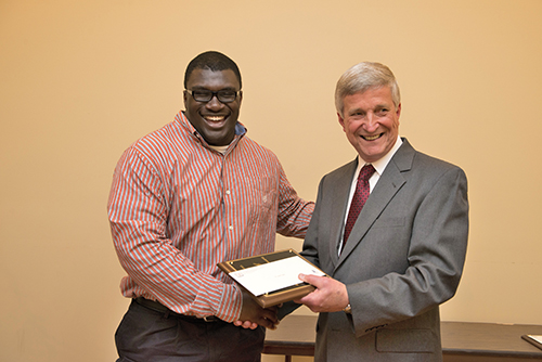 Jesse Kelley is congratulated by Dr. Bill Williams.