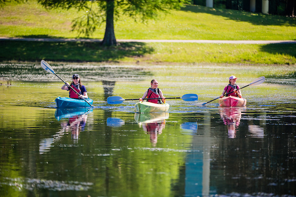 Students kayaking on gulf coast water.