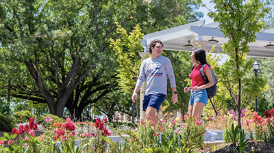 Two students walking across campus.