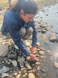 Student pointing to something in stream