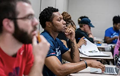 Students in class sitting at desks.