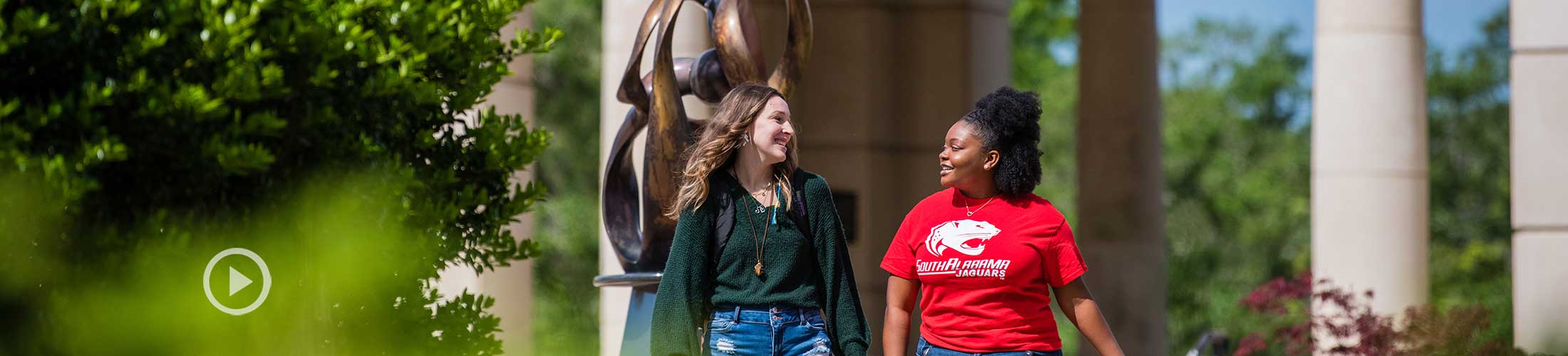 Students walking on USA campus outside of Moulton Tower.