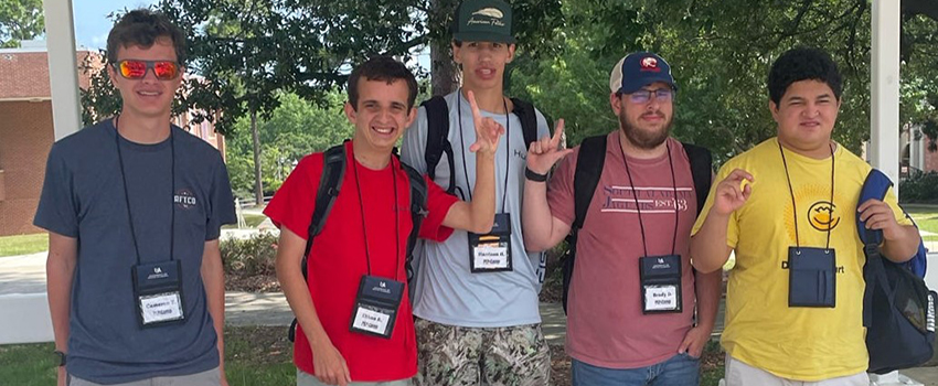 2023 Summer Camp Attendees holding up J sign for Jaguars.