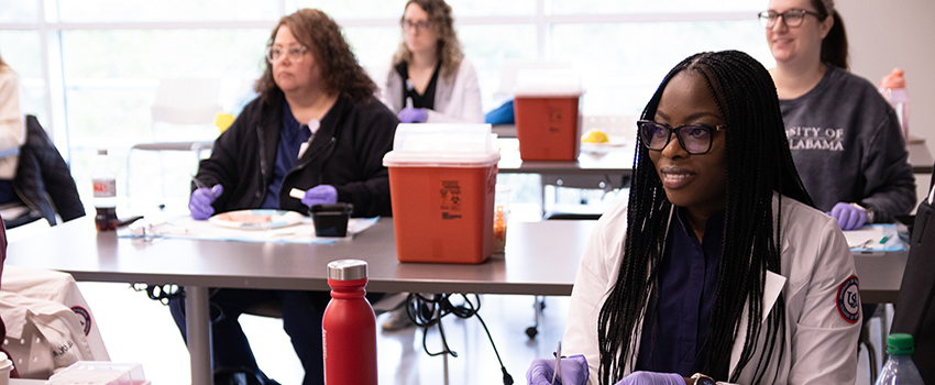 USA Nursing students dissecting in classroom.