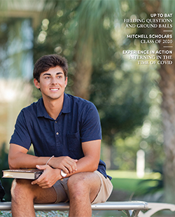 MCOB student sitting outside on bench with book in his lap.