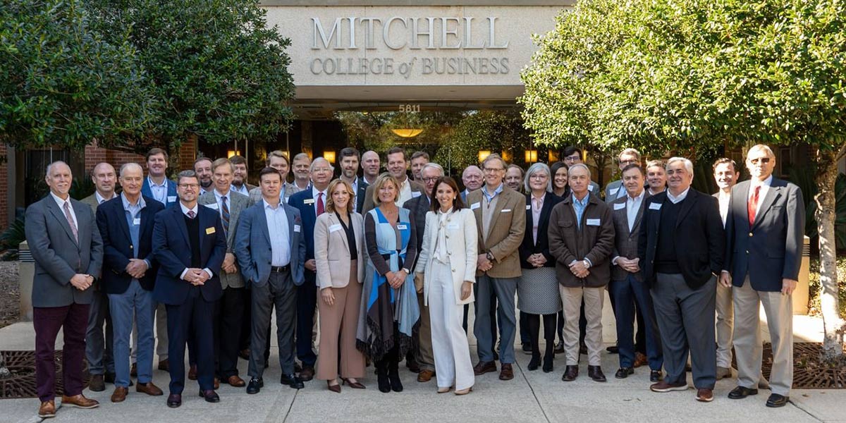 Founders Circle group picture in front of Mitchell College of Business.