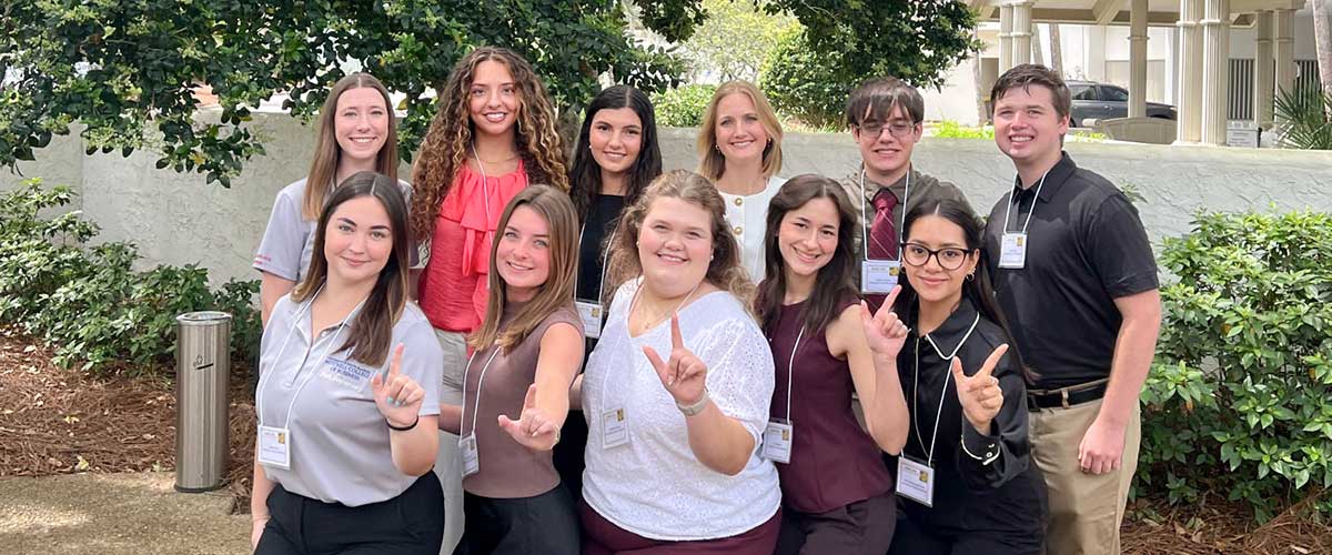 Group image of Undergraduate Research students outside.