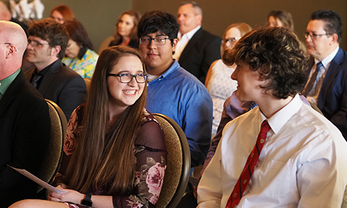 Two students smiling at each other at the Spring Celebration event