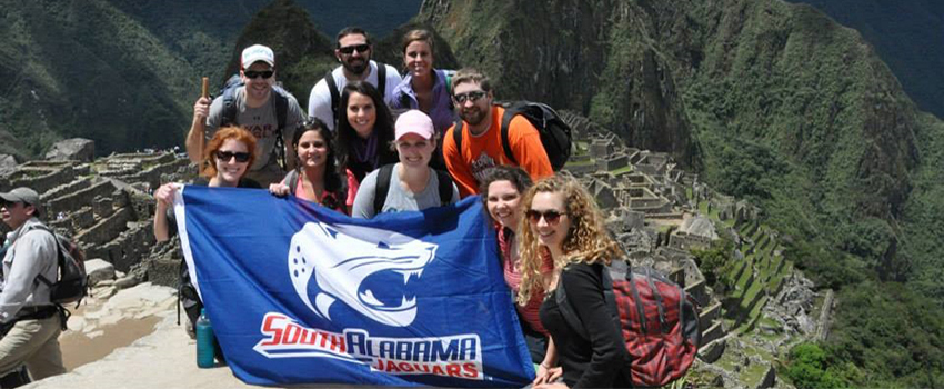 Study Abroad Students holding Jaguar Flag