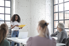 Woman speaking in front of group