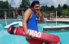 Image oflifeguard smiling pointing