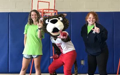 Summer Camp counselors with Southpaw in gym.