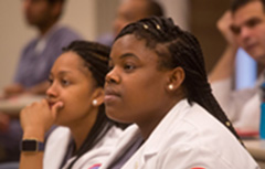 Student with white coats on in class