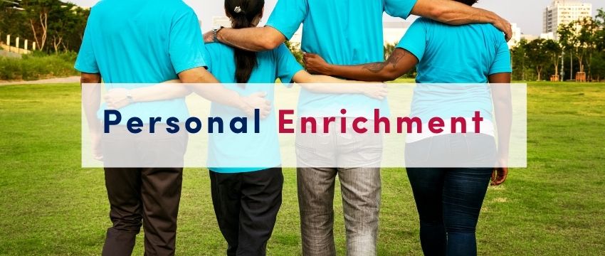 People with their backs turned, with their arms around each other in a field