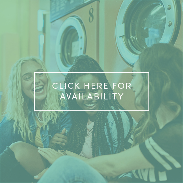 Three females talking sitting in laundry room