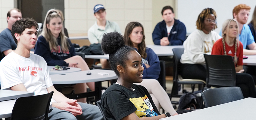 Students in classroom listening to professor.