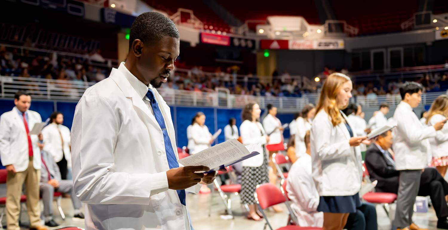 Third-year medical student Tahj Jones, joins his classmates in reciting the Medical Student Oath.
