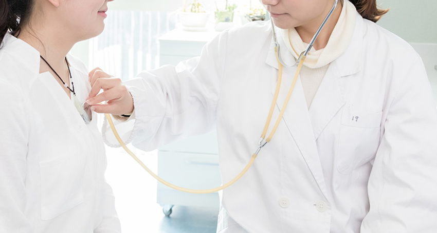 Nurse checking heart beat using stethoscope